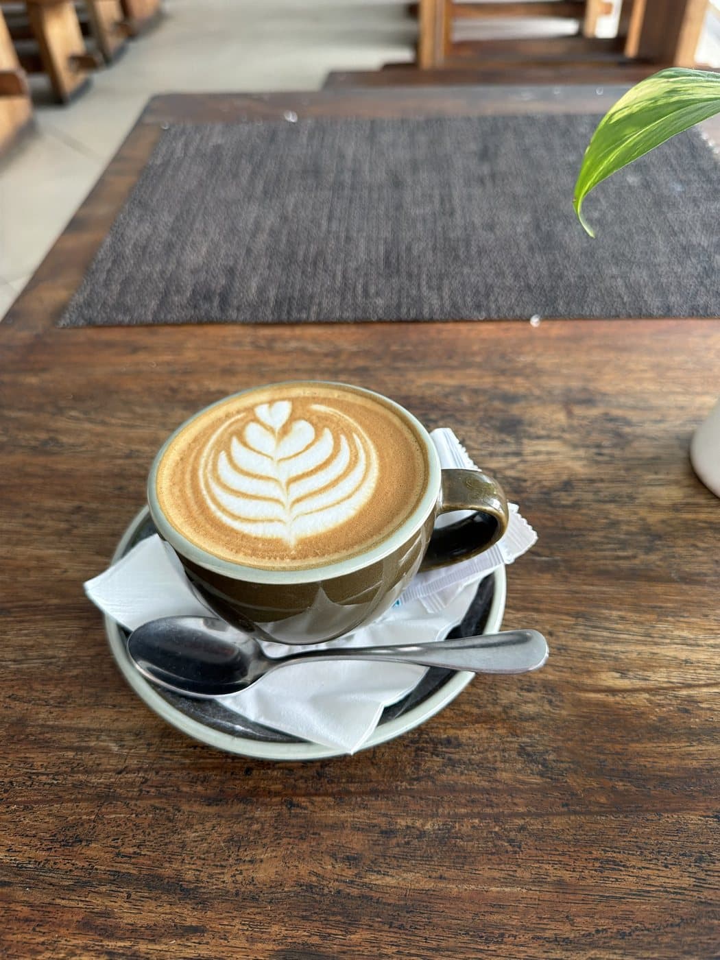 Example photo: latte art on a wooden café table